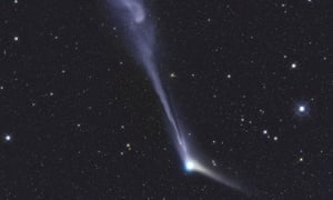 Comet Catalina stretches its tail across the sky.