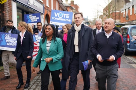 Andrew Griffith, Kemi Badenoch and Jeremy Hunt walk down Godalming High Street with some Tory party volunteers holding ‘Vote Conservative’ placards