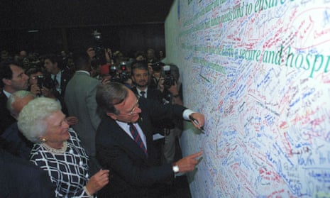 U.S. President George Bush is watched by first lady Barbara Bush as he signs the Earth Pledge at the Earth Summit in Rio de Janeiro, June 12, 1992.