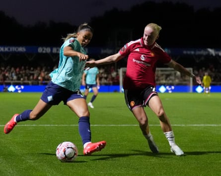The London City Lionesses winger Delphine Cascarino (left) shapes to cross the ball under pressure from the Manchester United winger Anna Sandberg (right) during their WSL match.