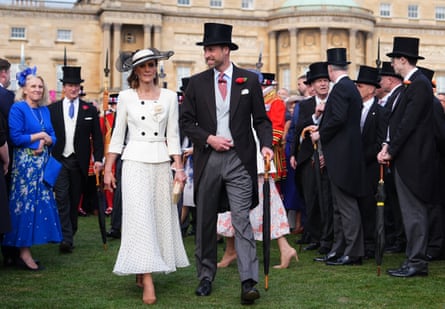 The Princess and Prince of Wales talk to guests at a garden party at Buckingham Palace