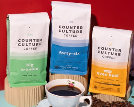 Three packages of counter culture coffee surrounding a cup of coffee