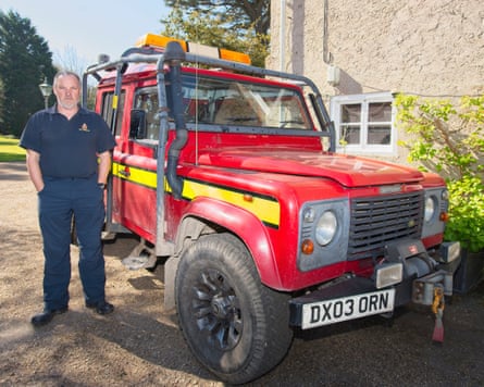 Martin Groom stood next to a red Land Rover