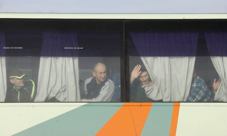 Prisoners look out from a bus before the exchange near the city of Bakhmut