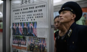A conductor reads an edition of the Rodong Sinmun newspaper covering the summit.