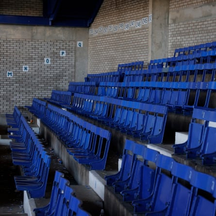 Empty wooden seats in the Main Stand