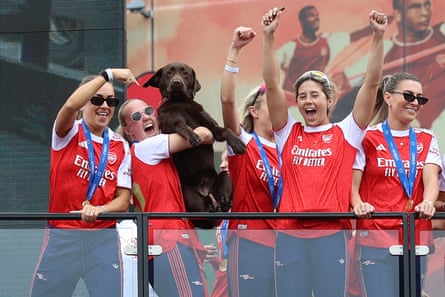 Beth Mead holds up Win the dog to the crowd at Emirates Stadium as the team celebrated their Champions League triumph