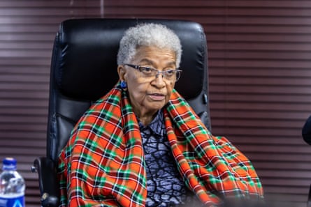 Ellen Johnson Sirleaf sits in an office chair draped in a colourful checked shawl,