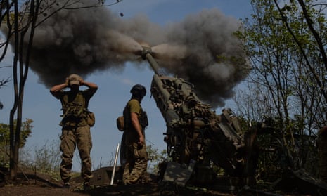 Ukrainian servicemen fire a M777 howitzer at a position on a front line in Kharkiv region, Ukraine, on 1 August.