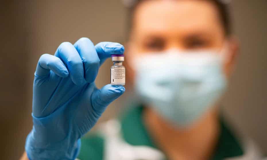 A nurse holds up a vial of the Pfizer/BioNTech Covid-19 vaccine