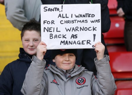 A young Sheffield United supporter holds up a sign in support of Neil Warnock