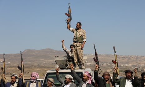 Houthis raise their guns during a protest near the capital, Sana’a, against the US-led strikes