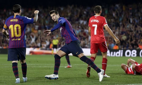 FC Barcelona’s Gerard Pique, center, celebrates with his teammate Lionel Messi after scoring.