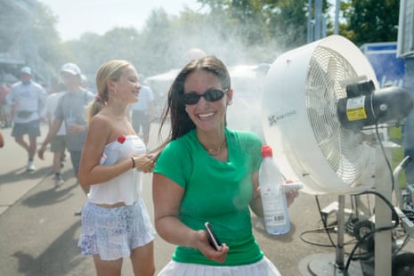 Fans cool off near mist machine