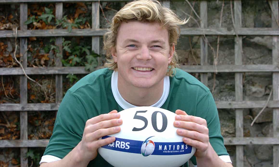 Brian O’Driscoll holds a rugby ball with the number 50, in Dublin in 2004