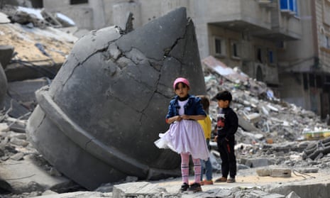 Children play among damaged buildings around the rubble of a mosque destroyed in an Israeli attack on Rafah.