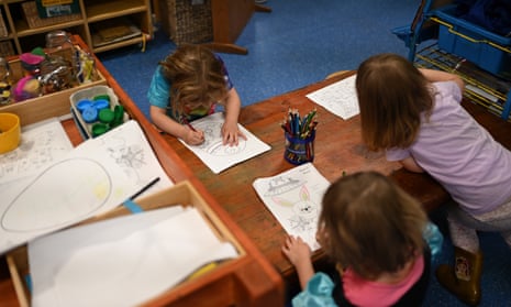children drawing around a table