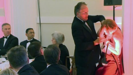 Conservative MP Mark Field grabs climate protester by the neck – video