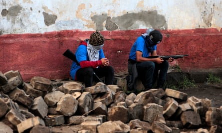 Supporters of President Ortega sit in a barricade after clashes with demonstrators in Monimbó, Masaya.