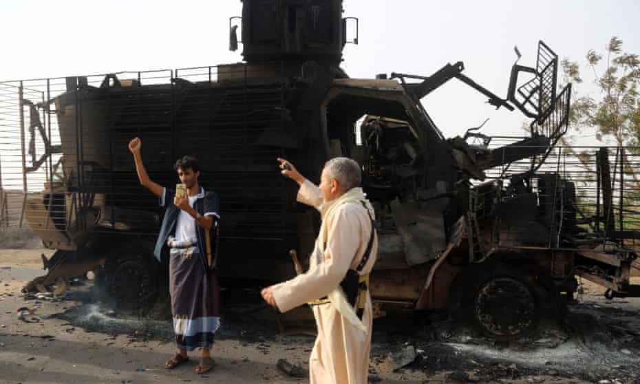 Yemenis check the wreckage of an armoured vehicle after clashes between Saudi-led coalition and Houthi forces near the coastal town of Hodeidah on Tuesday.