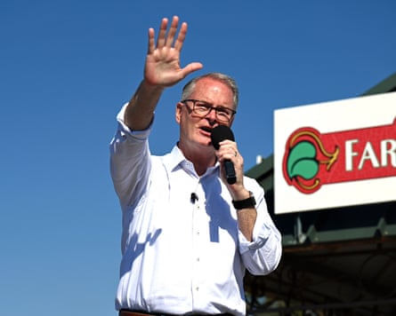 Senate candidate Adam Hamilton speaks into a microphone while waving at an outdoor campaign rally