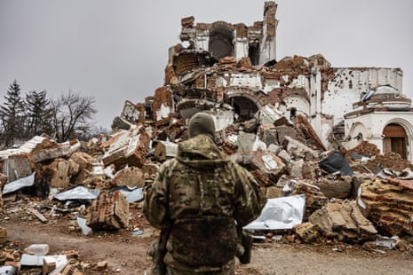 Caesar, a 50-year-old Russian who joined the Freedom of Russia Legion to fight on the side of Ukraine, stands in front of a destroyed monastery in Dolyna, eastern Ukraine on 26 December, 2022.