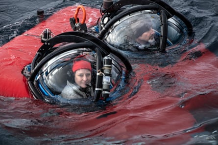 Dr Susanne Lockhart and John Hocevar, Greenpeace USA's Oceans Campaign Director and submersible pilot, in a red submersible surface in Antarctica.