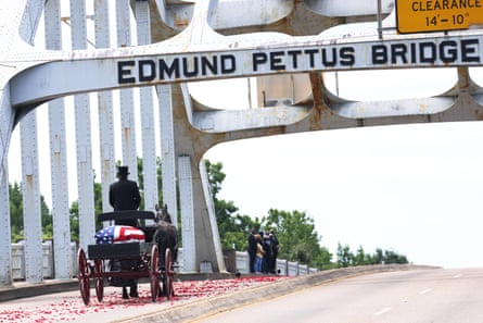 A horse drawn carriage crosses a bridge