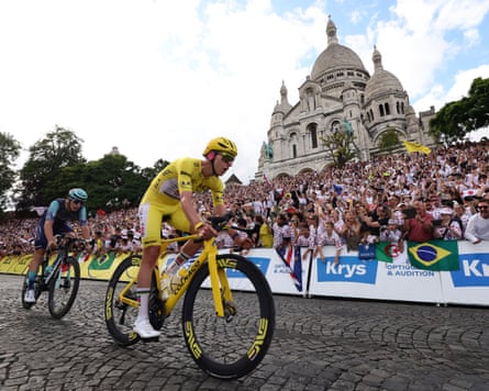 Slovenian rider Tadej Pogacar of UAE Team Emirates in action in front of the Sacré-Coeur as the cyclists ride through Paris’ Montmartre district