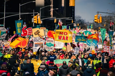 Crowds at a âÂÂNo Kingsâ protest hold colorful signs reading âÂÂNo Warâ and âÂÂUnion StrongâÂÂ.