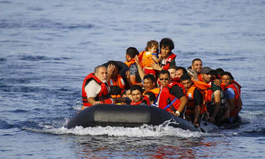 A dinghy full of people approaches the coast of Lesbos