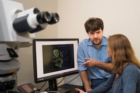 Deisseroth explaining an image on a computer screen to a woman who is seated in front of it