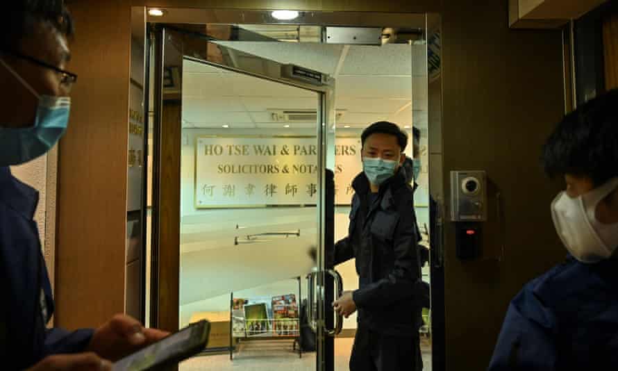 Police are seen inside the office of former pro-democracy lawmaker and lawyer Albert Ho after more than 50 Hong Kong opposition figures were arrested.