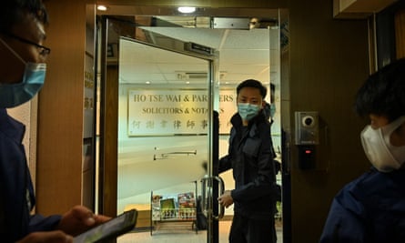Police are seen inside the office of former pro-democracy lawmaker and lawyer Albert Ho after more than 50 Hong Kong opposition figures were arrested.