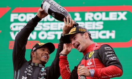Charles Leclerc celebrates on the podium with Lewis Hamilton after winning the Austrian Grand Prix in 2022
