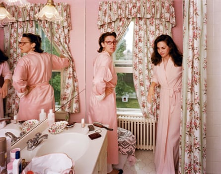 Two women in pink dressing gowns in a bathroom with pink patterned curtains, 1987