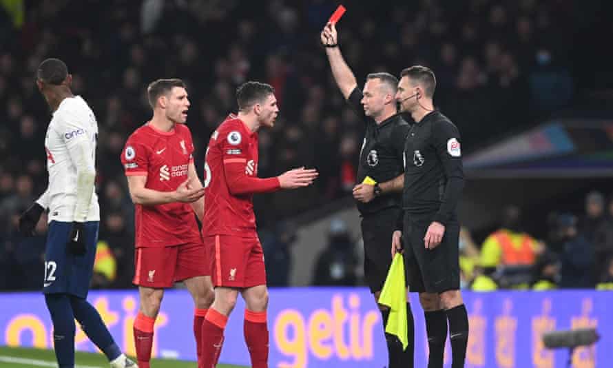Paul Tierney shows Andy Robertson the red card.
