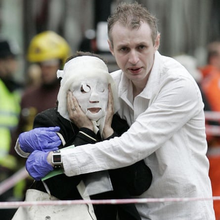 Paul Dadge helps Davinia Turrell stagger from Edgware Road Tube station after the London bombings of 7 July 2005.