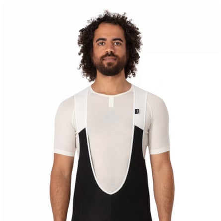 A person models the Rapha Merino base layer short-sleeved T-shirt underneath cycling bib shorts.