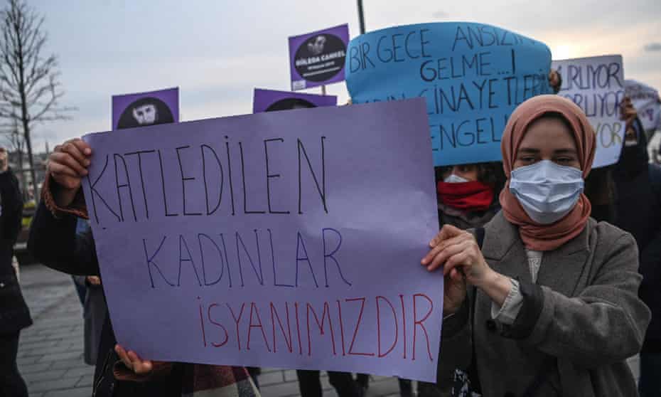 Women hold a placard at a protest