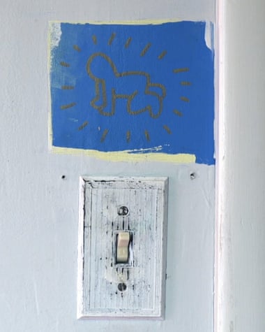Keith Haring's radiant child above the light switch as he was painted in his childhood home.