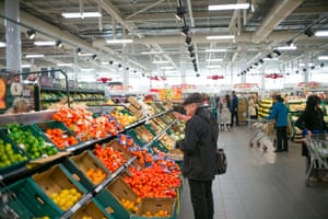 Shopper looking at fruit and vegetables in shop