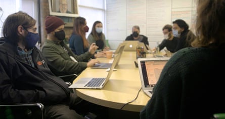 staff wearing masks and working on laptops