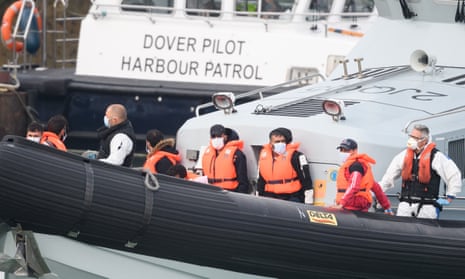 Migrants arrive in Dover on a Border Force vessel after being intercepted while crossing the Channel.