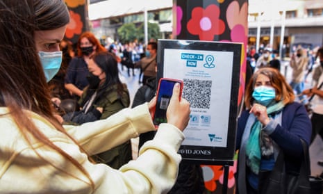 A customer scanning a QR code to enter a department store in Melbourne