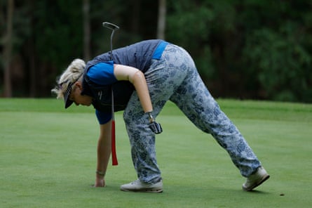 Tineke Loogman, a 65-year-old from Amsterdam, plucks the ball from the 15th hole