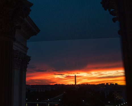 The sun sets behind the Washington Monument as seen from the US Capitol, in Washington DC, 30 September 2025.