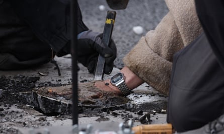 Police remove a climate activist who was glued to the asphalt in Berlin.