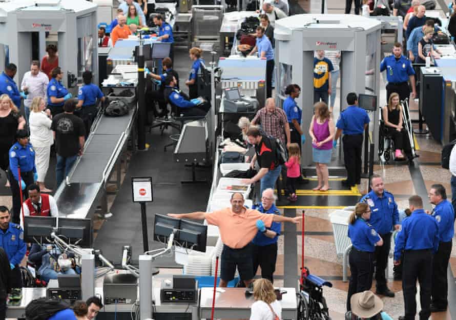 Travellers passing through security at Denver airport.