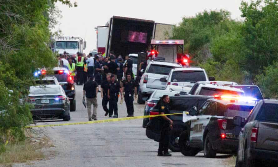 Law enforcement officers work at the scene where people were found dead inside a trailer truck in San Antonio, Texas